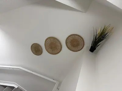 a white wall with three baskets on the wall at Brand New 1 Bedroom Basement Suite in Southwest in Edmonton