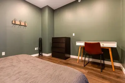 a bedroom with a desk and a bed at Peaks & Pines by Fernie Central Reservations in Fernie