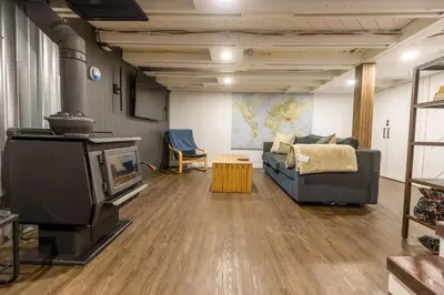 a living room with a tv and a couch at Peaks & Pines by Fernie Central Reservations in Fernie