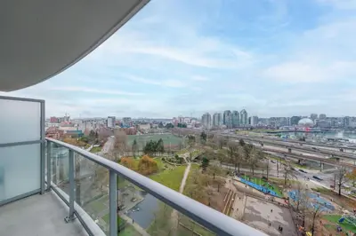 a view of a city from the balcony of a building at Modern Central Location with Pool Sauna & Jacuzzi in Vancouver