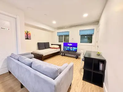 a living room with a couch and a tv at Private Guest Suite, Two Parking Spaces in Maple Ridge District Municipality