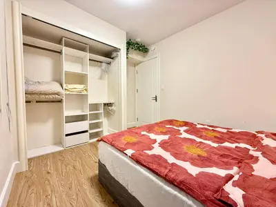 a bedroom with a bed and a walk in closet at Private Guest Suite, Two Parking Spaces in Maple Ridge District Municipality