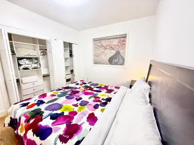 a bedroom with a bed with a colorful blanket at Private Guest Suite, One Parking Space in Maple Ridge District Municipality