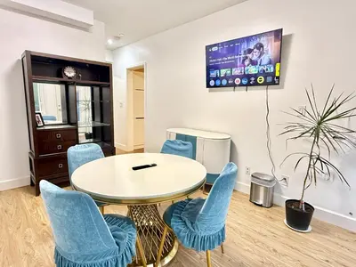 a room with a table and chairs and a tv at Private Guest Suite, One Parking Space in Maple Ridge District Municipality