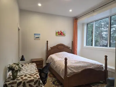 a bedroom with a bed and a window at Luxury Suite in New Villa in Surrey