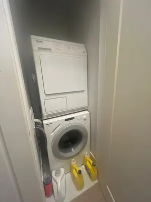 a washer and dryer in a small room at Luxury Suite in New Villa in Surrey
