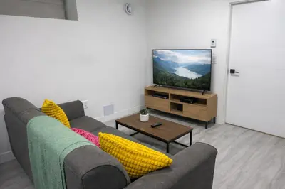 a living room with a couch and a flat screen tv at Comfort 2 BR Vancouver! in Vancouver