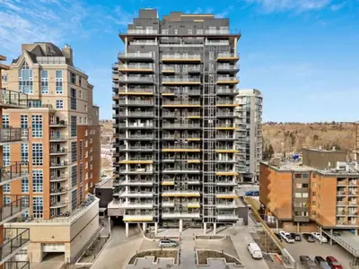 a tall building with balconies in a city at 1506 First and Park in Calgary
