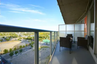 a balcony with a table and chairs on a building at Cozy Downtown Retreat with Stunning River Views in Calgary