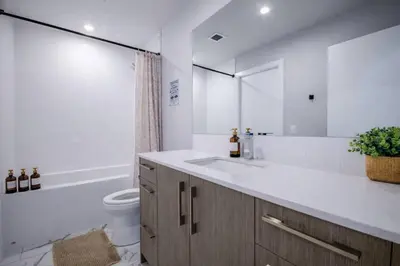 a bathroom with a sink and a toilet and a tub at 418 Frontier in Calgary