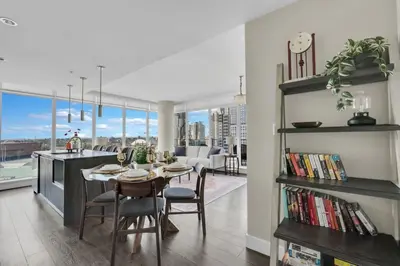 a dining room and living room with a table and chairs at 1409 Guardian South in Calgary