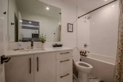 a white bathroom with a toilet and a sink at 431 Frontier in Calgary