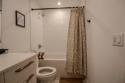 a bathroom with a toilet and a shower curtain at 431 Frontier in Calgary