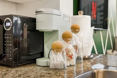 a kitchen counter with a microwave with three food inside at Stylish 2BR Downtown Condo By Arena Free Parking in Vancouver