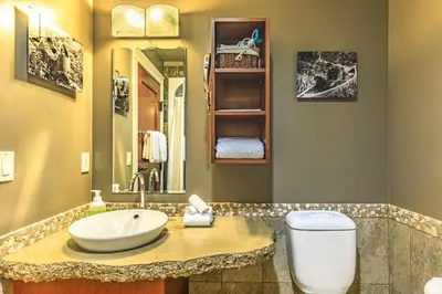 a bathroom with a sink and a toilet at Evergreen at Solara Resort in Canmore