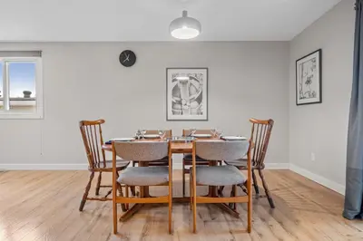a dining room with a wooden table and chairs at Entire Home - 2 Separate Units in Calgary