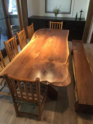 a wooden dining table with chairs around it at Radium Elk Park B & B in Radium Hot Springs