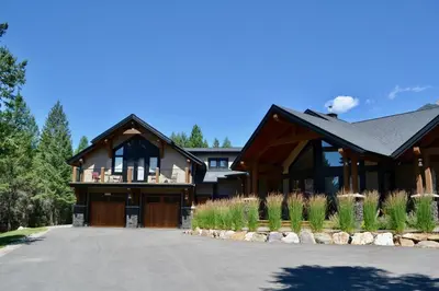 a large house with a driveway in front of it at Radium Elk Park B & B in Radium Hot Springs