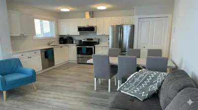 a kitchen with a couch and a table with chairs at True Ski-In-Ski-Out Rare 3-Bed Condo in Mount Washington