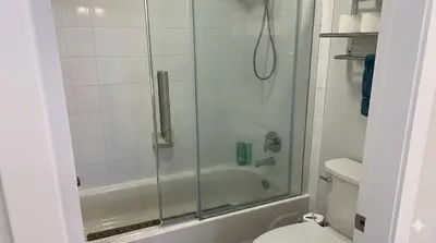 a bathroom with a shower and a toilet at True Ski-In-Ski-Out Rare 3-Bed Condo in Mount Washington