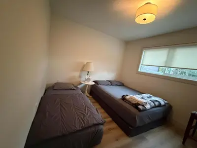 a bedroom with two beds and a window at Vancouver Downtown Apartment - Walk to SkyTrain & BC Place, Free Parking in Vancouver