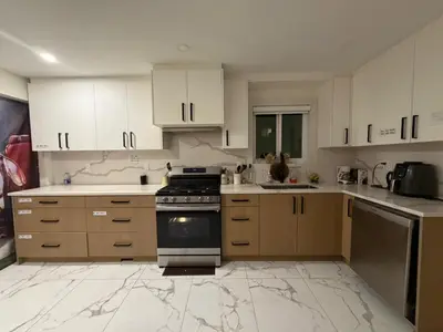 a kitchen with white cabinets and a stove at Vancouver Downtown Apartment - Walk to SkyTrain & BC Place, Free Parking in Vancouver