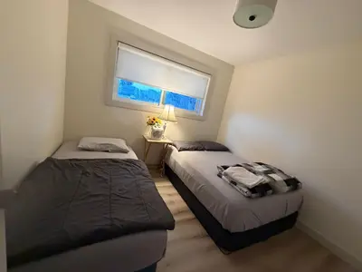 two beds in a small room with a window at Vancouver Downtown Apartment - Walk to SkyTrain & BC Place, Free Parking in Vancouver