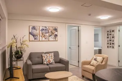 a living room with a couch and a chair at 4615 Inverness Street Vancouver King And Queen size 2 Bedrooms Suite with Private Entry in Vancouver