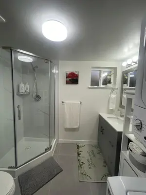 a bathroom with a shower and a toilet and a sink at 4615 Inverness Street Vancouver King And Queen size 2 Bedrooms Suite with Private Entry in Vancouver