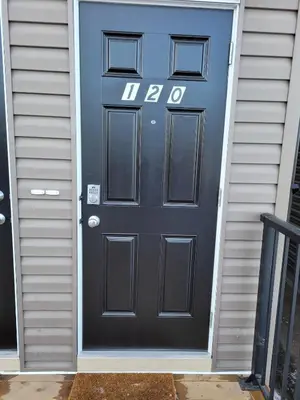 a black door with the number on it at Modern 2BR Suite with Private Yard in Calgary
