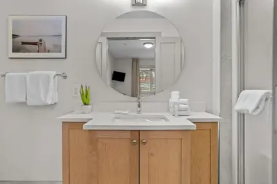 a bathroom with a sink and a mirror at Cedar and Stone - 2 Bed 2 Bath Condo with Heated Pool and Hot Tub in Canmore