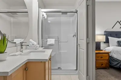 a bathroom with a shower and a sink at Cedar and Stone - 2 Bed 2 Bath Condo with Heated Pool and Hot Tub in Canmore