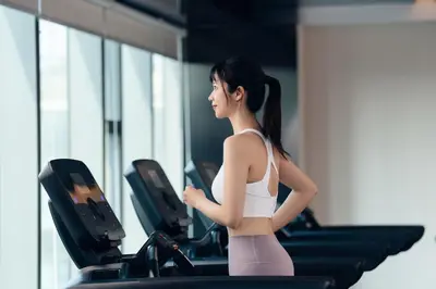 a woman running on a treadmill in a gym at Hyatt Place Vancouver/Metrotown in Burnaby
