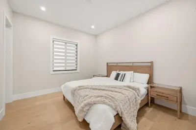 a white bedroom with a bed and a window at Luxury 5BR Modern Home Huge Open Layout in Langley