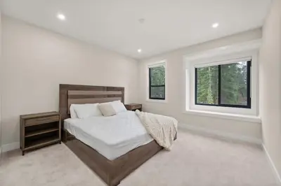 a white bedroom with a bed and two windows at Luxury 5BR Modern Home Huge Open Layout in Langley