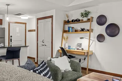 a living room with a couch and a table at Modern 1 Bedroom Retreat with Sofa Bed Comfort & Convenience Combined in Canmore