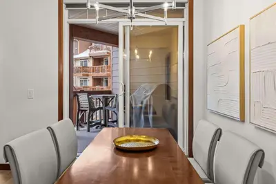 a dining room with a wooden table and chairs at Modern 1 Bedroom Retreat with Sofa Bed Comfort & Convenience Combined in Canmore