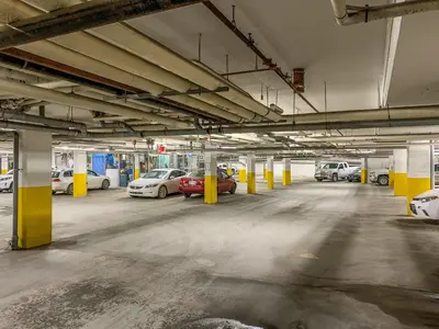 an empty parking garage with cars parked in it at Modern 1 Bedroom Retreat with Sofa Bed Comfort & Convenience Combined in Canmore