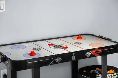 a table with a hockey game on it at 1BR Entertainment Space Projector and Games Room in Airdrie
