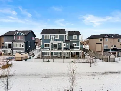 a group of houses on a beach in the snow at Waterfront 1BR Suite Private and Modern and Queen Bed in Airdrie