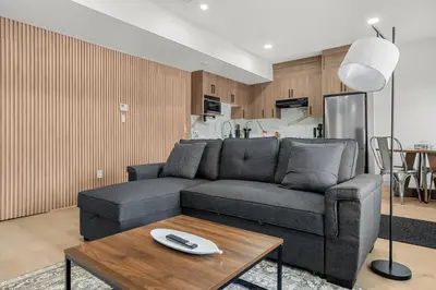 a living room with a couch and a table at Waterfront 1BR Suite Private and Modern and Queen Bed in Airdrie
