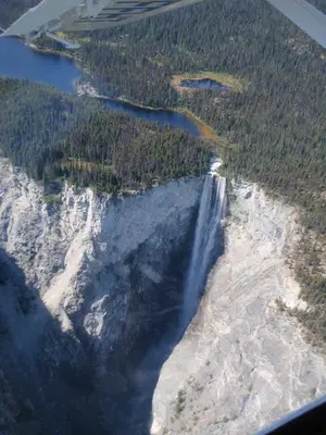 an aerial view of a waterfall and a river at Retreat Wilderness Inn in Nimpo Lake