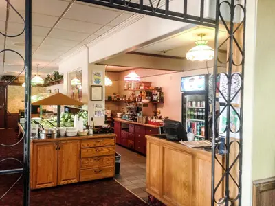 a restaurant with a counter in a room at Fox Creek Inn in Fox Creek