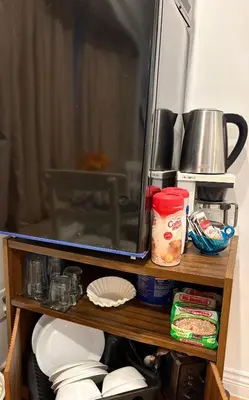 a tv on a wooden shelf with a microwave at private 1br guest suite Vancouver in Vancouver