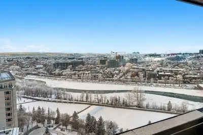 a view of a city in the snow from a building at Dt Spacious and Vibrant | Kng Bed| Outdoor patio in Calgary