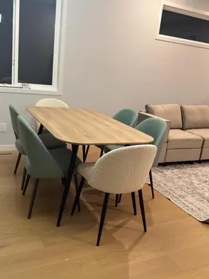 a wooden table and chairs in a living room at Cozy 1bedroom Mainfloor in Calgary
