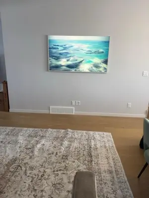 a living room with a rug and a painting on a wall at Cozy 1bedroom Mainfloor in Calgary