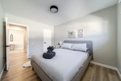 a bedroom with a bed with a stuffed animal on it at Newly Renovated, Bright & Cozy 3 bdrm Home - 6min from Rogers Arena in Edmonton