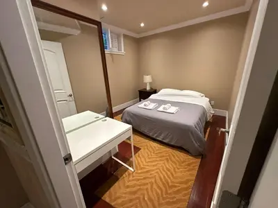 a small bedroom with a bed and a sink at Cozy & Equipped Room Right Next to Mall & Skytrain in Vancouver