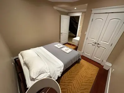 a small bedroom with a bed with towels on it at Cozy & Equipped Room Right Next to Mall & Skytrain in Vancouver